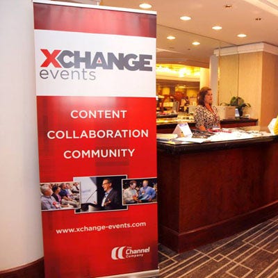 A person standing behind a reception desk Description automatically generated