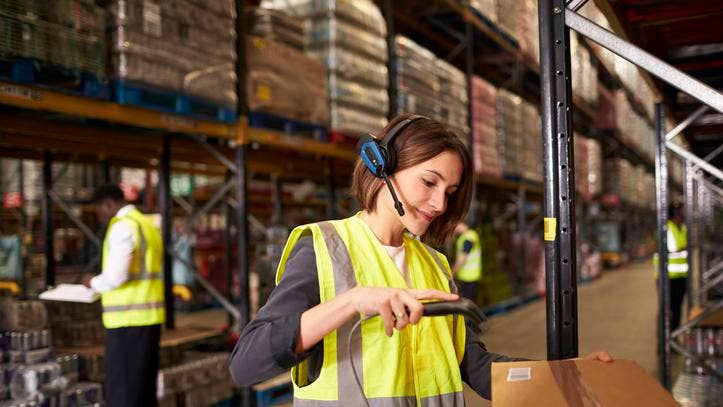 Woman using a barcode reader in a distribution warehouse
